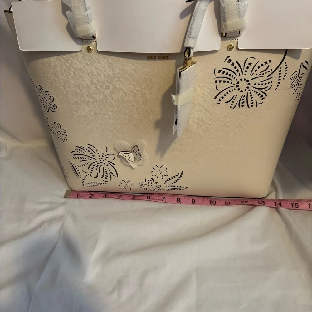 kate spade Cream Tote with Decorative Cutouts and Scarf Accent